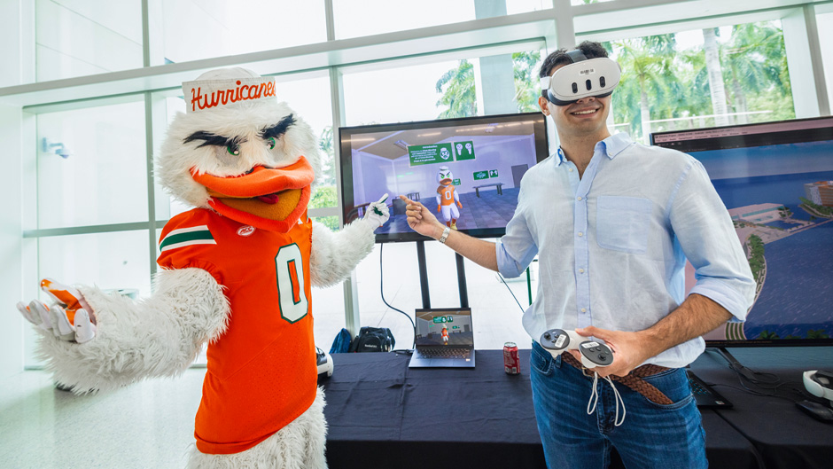 University of Miami mascot Sebastian the Ibis with a student trying out an XR experience